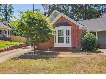 Charming brick home featuring a well-manicured lawn and a beautiful bay window at 2611 Leeshire Ct, Tucker, GA 30084