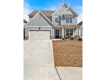Charming two-story home with a two-car garage, covered porch and attractive neutral gray siding at 90 Citrine Way, Acworth, GA 30101