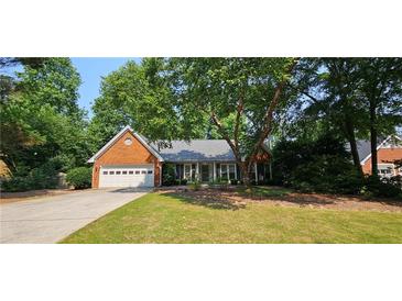 Charming brick home with attached garage and a well-maintained lawn at 2123 Condor Dr, Lawrenceville, GA 30044