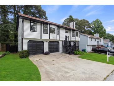 Charming two-story home with a well-maintained lawn and a two-car garage at 6322 Phillips Creek Dr, Lithonia, GA 30058