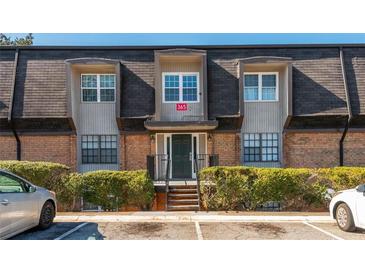 Charming brick townhome with a well-maintained exterior, front yard landscaping, and ample parking at 365 Winding River Dr # E, Atlanta, GA 30350