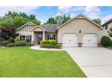 Inviting single-story home with manicured lawn and attached two-car garage at 1650 Walking Horse Trl, Cumming, GA 30041