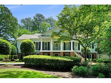 Stately home with manicured lawn, elegant columns, and dual staircase at 5545 Cross Gate Ct, Atlanta, GA 30327
