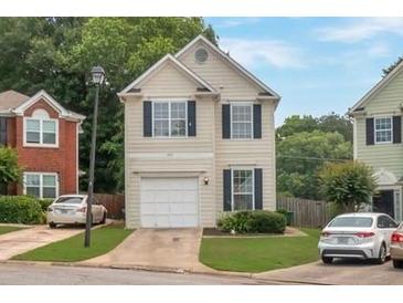 Charming two-story home with a light exterior, attached garage, and a well-manicured lawn at 3984 Oak Glenn Dr, Duluth, GA 30096