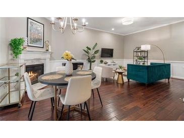 Inviting living room featuring a fireplace, a dining area, hardwood floors and stylish decor for a cozy and modern feel at 893 Piedmont Ne Ave # 3, Atlanta, GA 30309