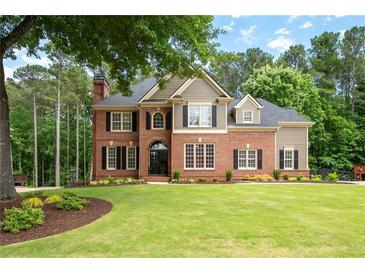 Beautiful two-story brick home with manicured lawn and mature trees in a desirable neighborhood at 6061 Meridian Nw Dr, Acworth, GA 30101