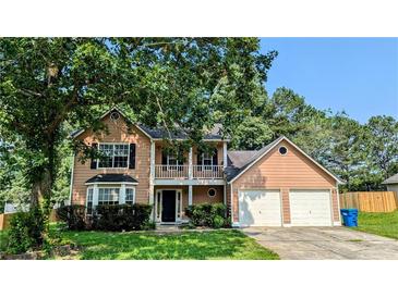 Charming two-story home featuring a spacious front yard and a two-car garage at 315 Marley Dr, Atlanta, GA 30349