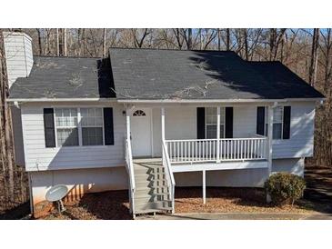 Charming home featuring white siding, black shutters, and a welcoming front porch at 1668 Independence Dr, Douglasville, GA 30134