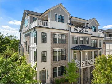 Stunning townhouse with a brick facade and multiple balconies, surrounded by lush greenery at 343 Concord St, Alpharetta, GA 30009