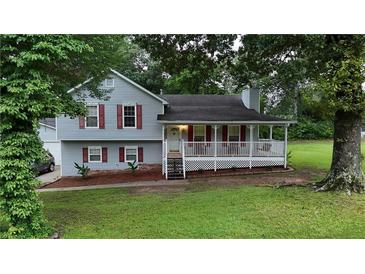 Charming two-story home features a inviting front porch, complemented by neatly landscaped yard and mature trees at 24 Lady Savannah Dr, Dallas, GA 30157