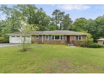 Charming single story brick home with a well maintained front lawn and driveway at 2720 Birchwood Sw Way, Marietta, GA 30060