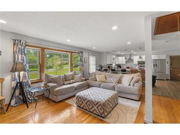 Bright living room featuring hardwood floors and open floor plan to the modern kitchen at 2720 Birchwood Sw Way, Marietta, GA 30060