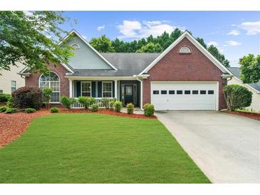 Charming brick home featuring a manicured lawn and a two-car garage at 4178 Mcever Park Dr, Acworth, GA 30101