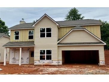 New two-story home featuring neutral siding, a two-car garage, and a covered front porch at 488 Charleston Pl, Villa Rica, GA 30180