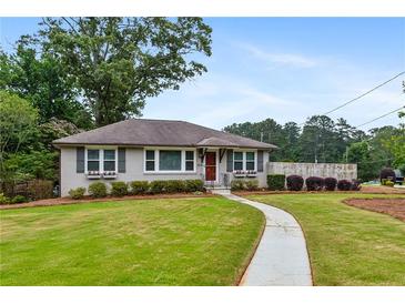 Charming single-story home with a well-manicured lawn and inviting walkway at 834 Timberland Se St, Smyrna, GA 30080