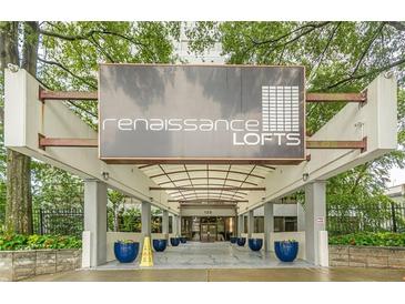 Welcoming entrance to Renaissance Lofts with covered entry and blue planters at 120 Ralph Mcgill Ne Blvd # 1502, Atlanta, GA 30308