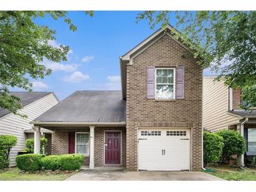 Charming brick-front home with a one-car garage and manicured landscaping at 222 Ben Ln, Fairburn, GA 30213