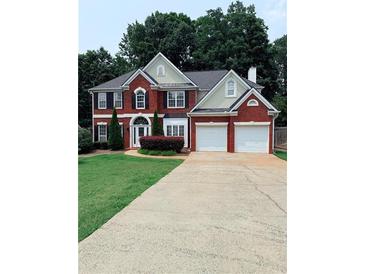 Charming two-story brick home with a well-manicured lawn and a spacious two-car garage at 1991 Westover Nw Ln, Kennesaw, GA 30152