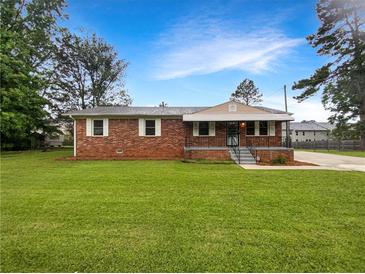 Charming brick home with a well-maintained front yard and inviting curb appeal at 145 Washington St, Mcdonough, GA 30253