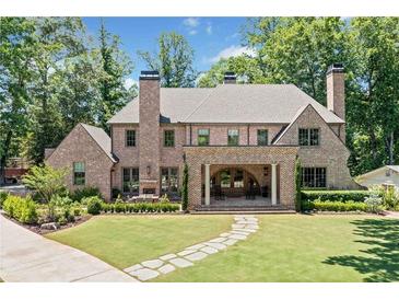 Stunning brick home featuring a sprawling lawn, stone pathway and inviting covered porch at 3146 Frontenac Ne Ct, Atlanta, GA 30319