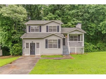 Charming two-story home features a front porch, manicured lawn, and welcoming curb appeal at 6114 Leverett Dr, Lithonia, GA 30038
