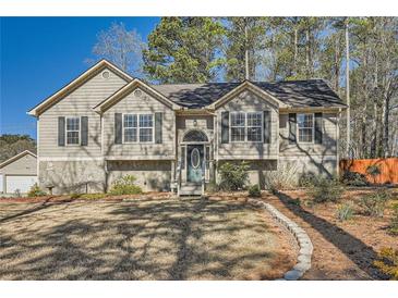 Charming home featuring a well-manicured front yard, stone accents and welcoming entrance at 13 Cliff Ct, Villa Rica, GA 30180
