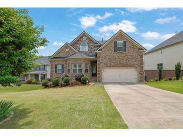 Charming brick two-story home with a well-manicured lawn and a two-car garage at 6370 Stillwood Ln, Cumming, GA 30041