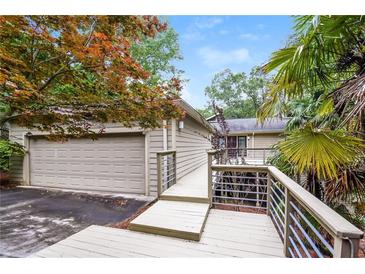 The exterior shows a house with a two-car garage, a wooden deck, and metal railings at 3985 Loch Highland Ne Pass, Roswell, GA 30075