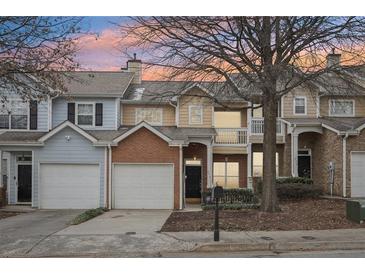 Charming townhome exterior with attached garage and well-maintained landscaping at 577 Reed Se St, Atlanta, GA 30312