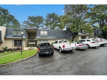Exterior view of the condominium complex with multiple parking spaces available for residents and visitors at 123 Maison Nw Pl, Atlanta, GA 30327