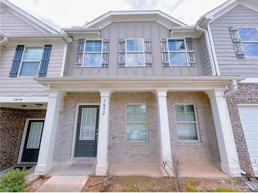 Charming townhome with a covered front porch and well-maintained exterior at 1892 Old Dogwood, Jonesboro, GA 30238