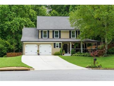 Charming two-story home with a well-manicured lawn, two-car garage, and inviting front porch at 2263 Hill Creek Way, Marietta, GA 30062