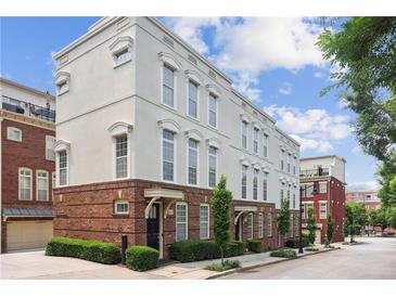 Charming townhome with brick accents, large windows, and manicured landscaping at 306 Masons Row, Marietta, GA 30060