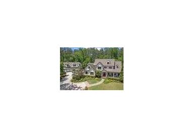 Beautiful two-story home with a detached garage, a lush green lawn, and mature trees at 193 Stonegate Trl, Carrollton, GA 30116