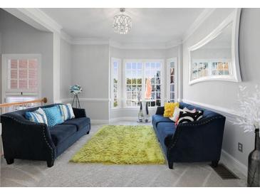 Bright living room with two sofas, plush rug, and a bay window offering abundant natural light at 1286 Creekside Se Ter, Smyrna, GA 30082