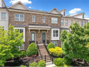 Charming brick townhome with well-manicured landscaping and a welcoming entrance at 1094 Township Sq, Alpharetta, GA 30022