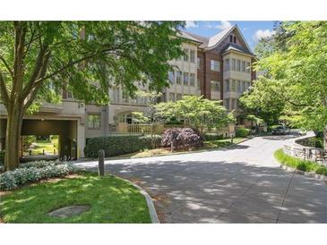 Beautiful multi-story building featuring brick and stone accents, lush landscaping, and a private entrance at 1717 N Decatur Ne Rd # 117, Atlanta, GA 30307