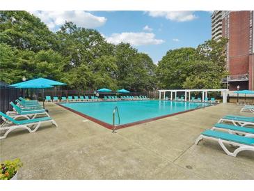 Resort style community pool with lounge chairs and umbrellas for relaxing by the water at 377 Ralph Mcgill Ne Blvd # C, Atlanta, GA 30312