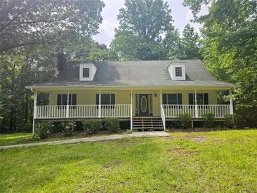 Charming single-story home with a welcoming front porch and well-manicured lawn at 8291 Highway 5, Whitesburg, GA 30185