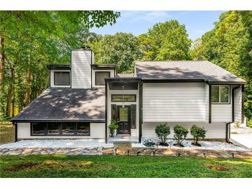 Contemporary home featuring a modern exterior, unique architectural details, and a well-maintained yard at 5219 Legendary Ln, Acworth, GA 30102