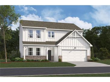 Charming two-story home with white siding, a brick foundation and an attached two-car garage at 138 Henley St, Canton, GA 30114