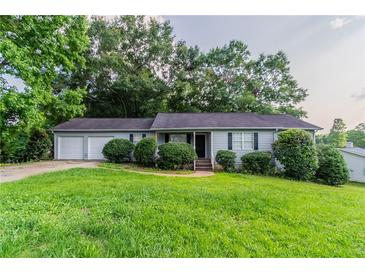 Charming one-story home with a two-car garage and well-maintained lawn at 310 Rippling Brook Trce, Palmetto, GA 30268