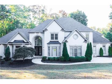Stunning two-story home with manicured lawn, a circular driveway, and a stately facade at 3258 Bransley Way, Duluth, GA 30097
