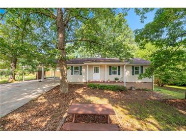 Charming single-story home with green shutters, front yard, and covered parking at 245 Amanda Ct, Stockbridge, GA 30281