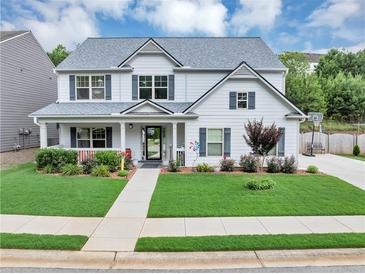 Charming two-story home with a well-manicured lawn, covered porch, and lovely landscaping at 226 Creek View Ln, Acworth, GA 30102
