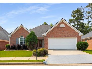 Charming single-story brick home featuring a two-car garage and well-maintained landscaping at 115 Pinnacle Ln, Mcdonough, GA 30253