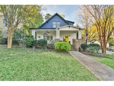 Charming home featuring a welcoming front porch, lush lawn, and mature landscaping, inviting curb appeal at 907 Eden Se Ave, Atlanta, GA 30316