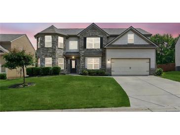 Beautiful two-story home with well-manicured lawn, gray brick, and two-car garage at 4650 Orchard View Way, Cumming, GA 30028