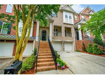 Beautiful brick townhome featuring an inviting entrance and manicured landscaping at 3130 Woodwalk Se Trce # 8, Atlanta, GA 30339
