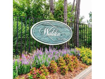 Welcoming Walden on Lenox community sign surrounded by vibrant landscaping and a decorative black fence at 36 Saint Claire Ne Ln, Atlanta, GA 30324